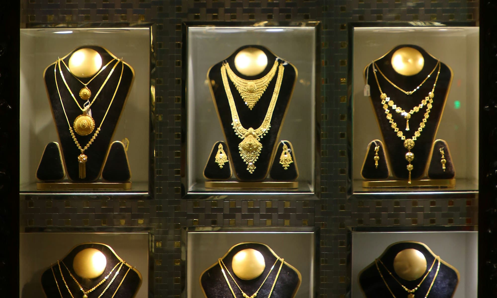 A display of DIORILLA gold-toned fashion jewelry